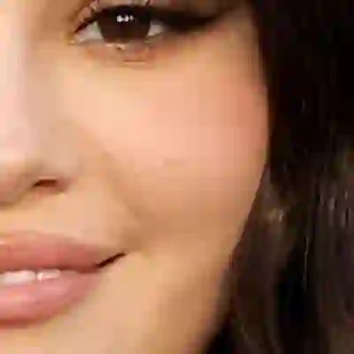 Selena Gomez's skin tone — warm peachy-golden with a light-to-medium depth